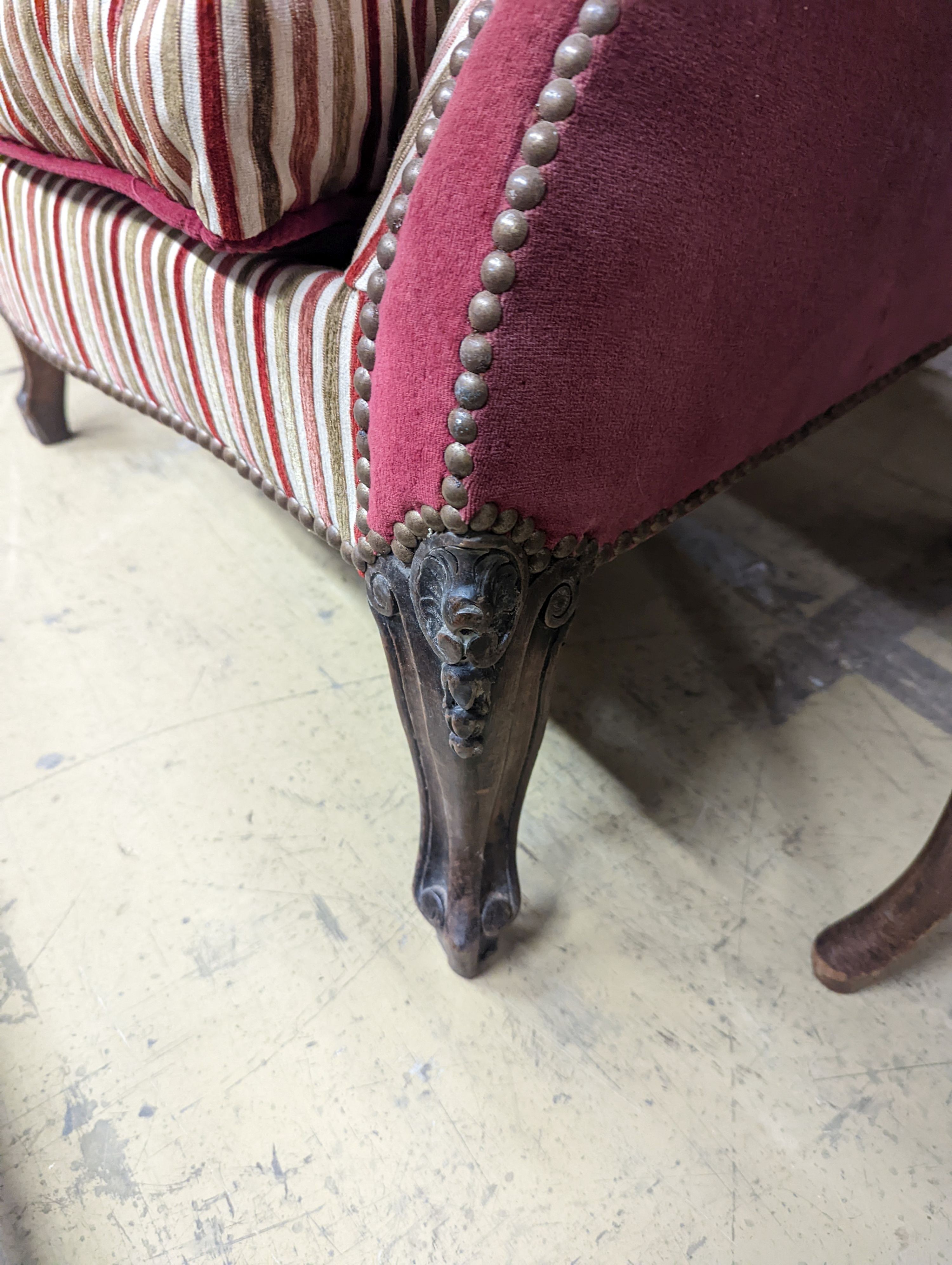 A 19th century Louis XVI style upholstered wing armchair, width 71cm, depth 74cm, height 104cm